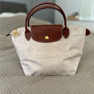 Longchamp small top handle handbag. Le Pliage folds down into a notebook size.